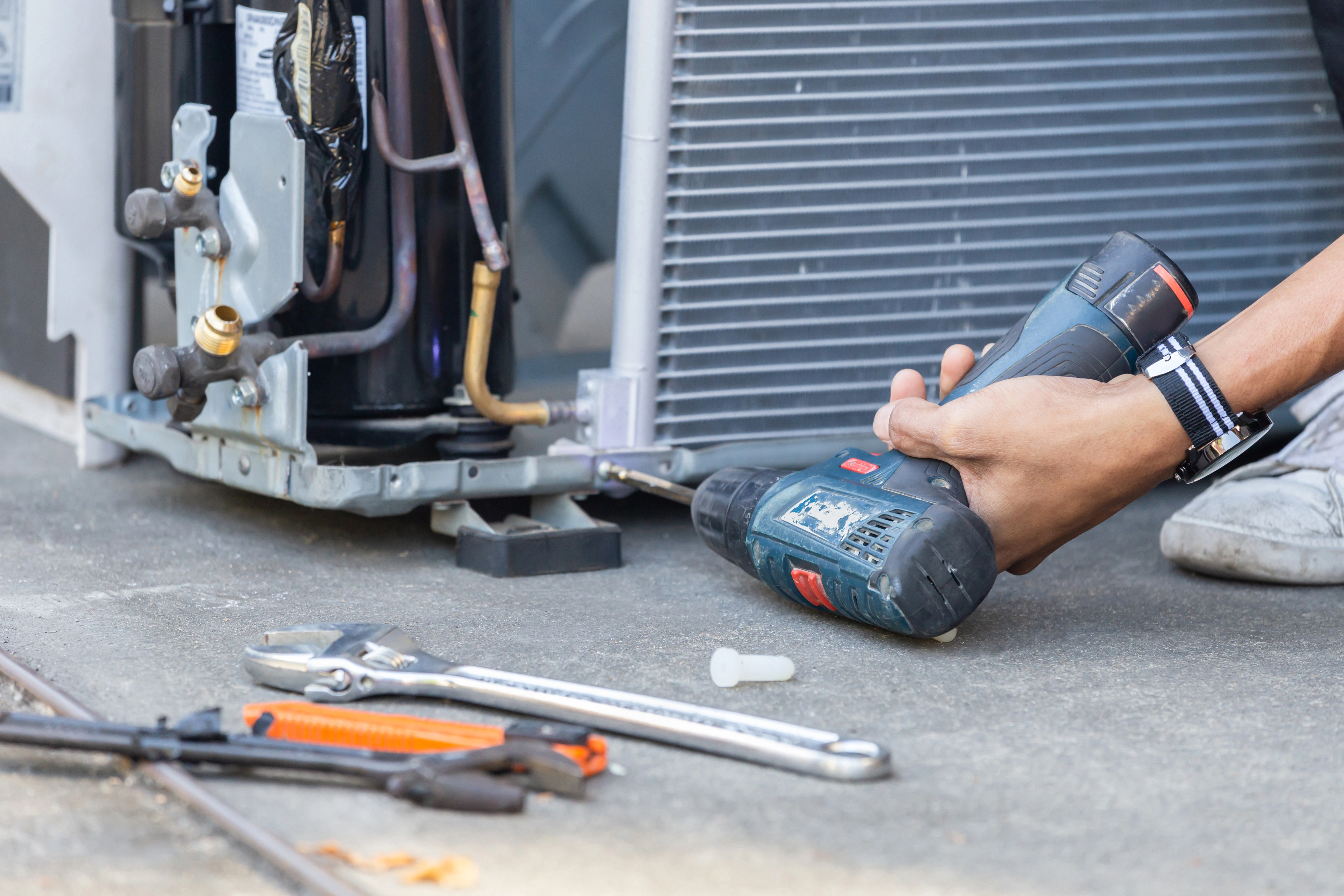 An Air Dynamics technician performing HVAC services in Tulsa.