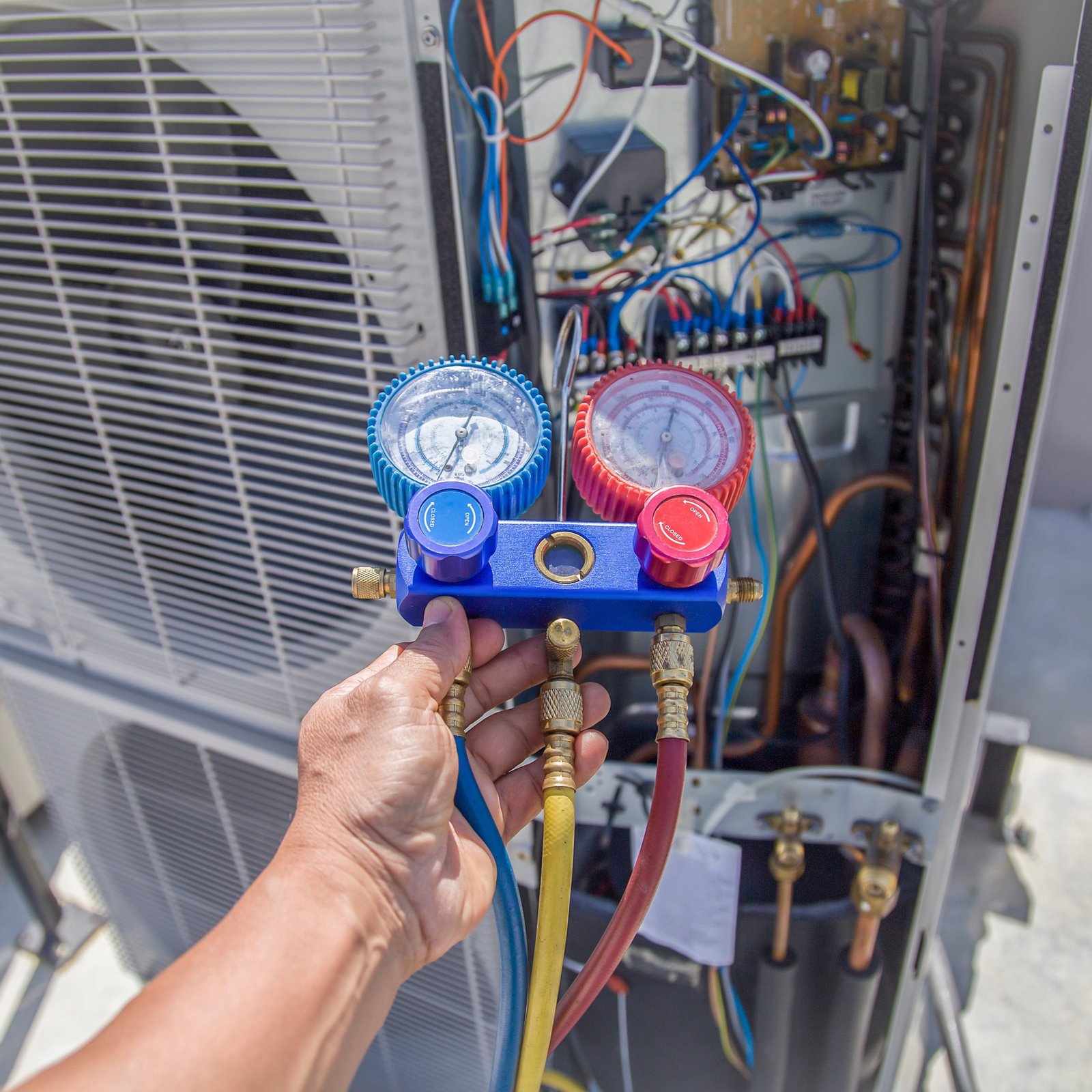 Air Dynamics of Tulsa HVAC Technician performing repair work.